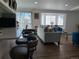 Open concept view from kitchen looking into inviting living room featuring modern furniture and hardwood floors at 9133 W Cedar Dr # A, Lakewood, CO 80226