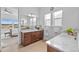 Bright bathroom with double vanity, granite countertops, and a picturesque view from the adjacent bedroom at 7814 S Grand Baker Ct, Aurora, CO 80016