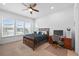 Well-lit bedroom featuring a large window, desk, and wood furniture at 7814 S Grand Baker Ct, Aurora, CO 80016