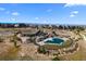 Community center and pool with a playground, grassy area and mountain views in the distance under a blue sky at 7814 S Grand Baker Ct, Aurora, CO 80016