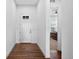 A bright entryway featuring hardwood floors and a modern white front door with sidelight windows at 7814 S Grand Baker Ct, Aurora, CO 80016