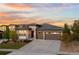 Inviting single-story home featuring a stone facade, well-manicured lawn, and a spacious three-car garage at 7814 S Grand Baker Ct, Aurora, CO 80016