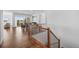 Bright foyer with hardwood floors and staircase leading to the upper level, featuring a glimpse of a sunlit dining area at 7814 S Grand Baker Ct, Aurora, CO 80016