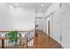 Hallway with hardwood floors, wood railing, and access to a sliding barn door at 7814 S Grand Baker Ct, Aurora, CO 80016