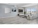 Bright living room with contemporary decor and large windows offering natural light at 7814 S Grand Baker Ct, Aurora, CO 80016