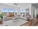 Cozy living room featuring hardwood floors, many windows and a plush white sofa at 7814 S Grand Baker Ct, Aurora, CO 80016