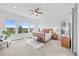 Bright main bedroom with a ceiling fan, a large window, and wood furniture at 7814 S Grand Baker Ct, Aurora, CO 80016