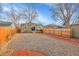 Large backyard with gravel, a wooden fence, and a deck at 5065 Eliot St, Denver, CO 80221