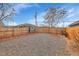 Gravel backyard with a wooden fence and a storage shed at 5065 Eliot St, Denver, CO 80221