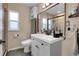 Clean bathroom with a vanity, toilet, and updated shower at 5065 Eliot St, Denver, CO 80221