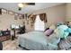 Spacious bedroom with a queen bed, workspace, and ceiling fan at 5065 Eliot St, Denver, CO 80221