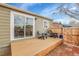 Private backyard deck with two comfortable adirondack chairs at 5065 Eliot St, Denver, CO 80221