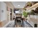 Bright dining room with a table, chairs, and abundant plants at 5065 Eliot St, Denver, CO 80221