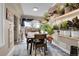 Charming dining area with a table and chairs, and a wall of plants at 5065 Eliot St, Denver, CO 80221