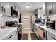 Modern kitchen with stainless steel appliances and white countertops at 5065 Eliot St, Denver, CO 80221