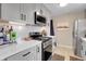 Modern kitchen with gray cabinets, white countertops, and stainless steel appliances at 5065 Eliot St, Denver, CO 80221