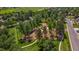 Aerial view of park featuring a playground, green spaces, mature trees, and paved walkways at 10 Oakmont Ln, Littleton, CO 80127