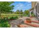 Private backyard featuring a large, stone patio and expansive lawn at 10 Oakmont Ln, Littleton, CO 80127
