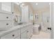Bright bathroom featuring a soaking tub, glass shower, double vanity, and tiled floor at 10 Oakmont Ln, Littleton, CO 80127