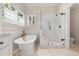Bright bathroom featuring a soaking tub, glass shower and tiled floor at 10 Oakmont Ln, Littleton, CO 80127