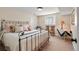 Comfortable bedroom featuring a metal bed frame, carpeting, and a bright window at 10 Oakmont Ln, Littleton, CO 80127