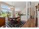 Open-concept dining room featuring hardwood floors, chandelier, and large windows at 10 Oakmont Ln, Littleton, CO 80127