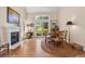 Bright dining room with hardwood floors, fireplace and views of the outdoor area at 10 Oakmont Ln, Littleton, CO 80127