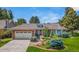 Charming ranch-style home featuring a brick facade, tile roof, and well-maintained landscaping at 10 Oakmont Ln, Littleton, CO 80127