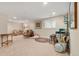 Expansive living room featuring neutral carpeting, ample seating, and natural light at 10 Oakmont Ln, Littleton, CO 80127
