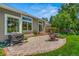 Paver patio featuring outdoor seating, grill, mature landscaping, and lush green grass at 10 Oakmont Ln, Littleton, CO 80127