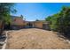 Expansive backyard with brick home, patio, and wooden fence under a clear blue sky at 1497 S Garfield St, Denver, CO 80210