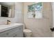 Bright bathroom featuring updated vanity and toilet, complete with white marble tile at 1497 S Garfield St, Denver, CO 80210