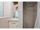 Cozy bathroom shower featuring ceramic tile, a shower head, and a window at 1497 S Garfield St, Denver, CO 80210