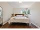 Comfortable bedroom featuring natural light from two windows and dark hardwood floors at 1497 S Garfield St, Denver, CO 80210