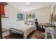 Bedroom with desk, chair, and large windows providing lots of natural light at 1497 S Garfield St, Denver, CO 80210