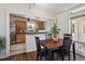 Cozy dining area with a view into the kitchen, featuring hardwood floors and ample natural light at 1497 S Garfield St, Denver, CO 80210