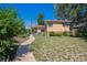 Charming brick home with a well-manicured lawn and inviting walkway, perfect for suburban living at 1497 S Garfield St, Denver, CO 80210