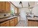 Functional kitchen with wooden cabinets, tiled backsplash, and ample counter space for culinary creations at 1497 S Garfield St, Denver, CO 80210