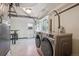 Basement laundry area featuring a newer washer and dryer on a tiled floor at 1497 S Garfield St, Denver, CO 80210