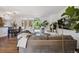 Open-concept living room with hardwood floors, modern furniture, and large windows for natural light and garden view at 1497 S Garfield St, Denver, CO 80210