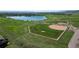 Aerial view of a baseball field with lake and green space at 12919 W Burgundy Dr, Littleton, CO 80127