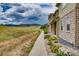 Sidewalk view with landscaping, townhouses, and mountain views at 12919 W Burgundy Dr, Littleton, CO 80127