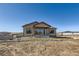 Exterior shot of house with a covered patio and a young tree in the yard at 5134 Cupule Trl, Castle Rock, CO 80104