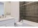 Modern bathroom featuring sleek black tile shower and white fixtures at 5134 Cupule Trl, Castle Rock, CO 80104