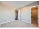 A view of an empty bedroom with light gray walls and neutral carpet at 5134 Cupule Trl, Castle Rock, CO 80104