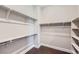 Empty walk-in closet featuring installed shelving and hardwood floors; a blank slate for organization at 5134 Cupule Trl, Castle Rock, CO 80104