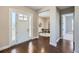 Bright foyer with hardwood floors leads to a living space with a white door at 5134 Cupule Trl, Castle Rock, CO 80104