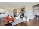 Elegant living room features a cozy fireplace, modern furnishings, and hardwood flooring at 5134 Cupule Trl, Castle Rock, CO 80104