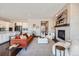 Open-concept living room features a modern fireplace and seamless flow into the gourmet kitchen at 5134 Cupule Trl, Castle Rock, CO 80104