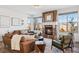 Living room with a cozy fireplace and abundant natural light at 2388 S Loveland Way, Lakewood, CO 80228